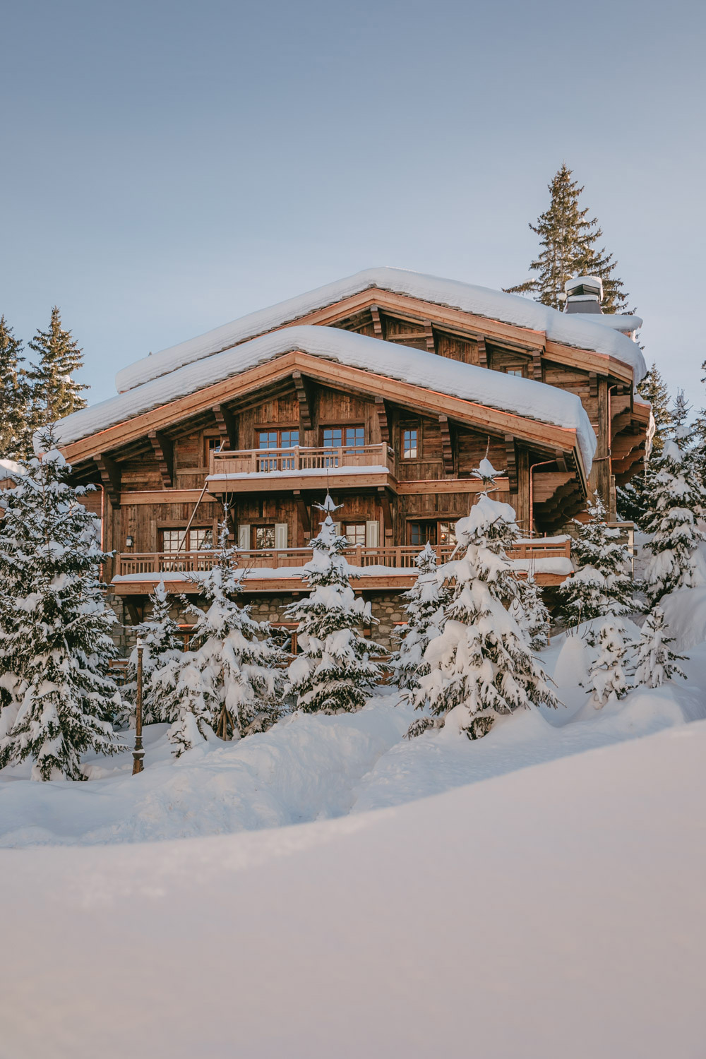 Airelles courchevel private chalet covered in snow at sunrise