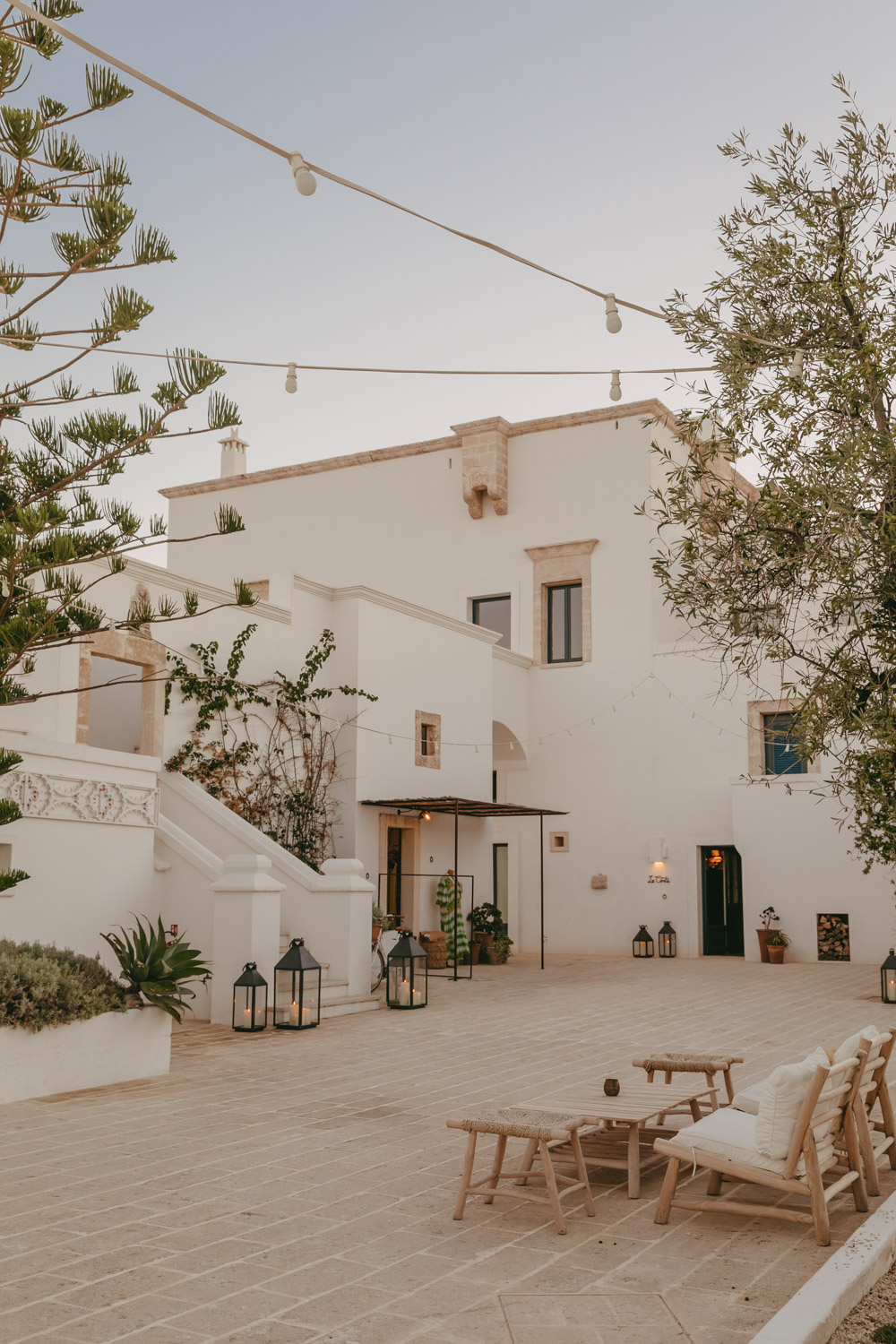 white masseria with olive trees in the foreground