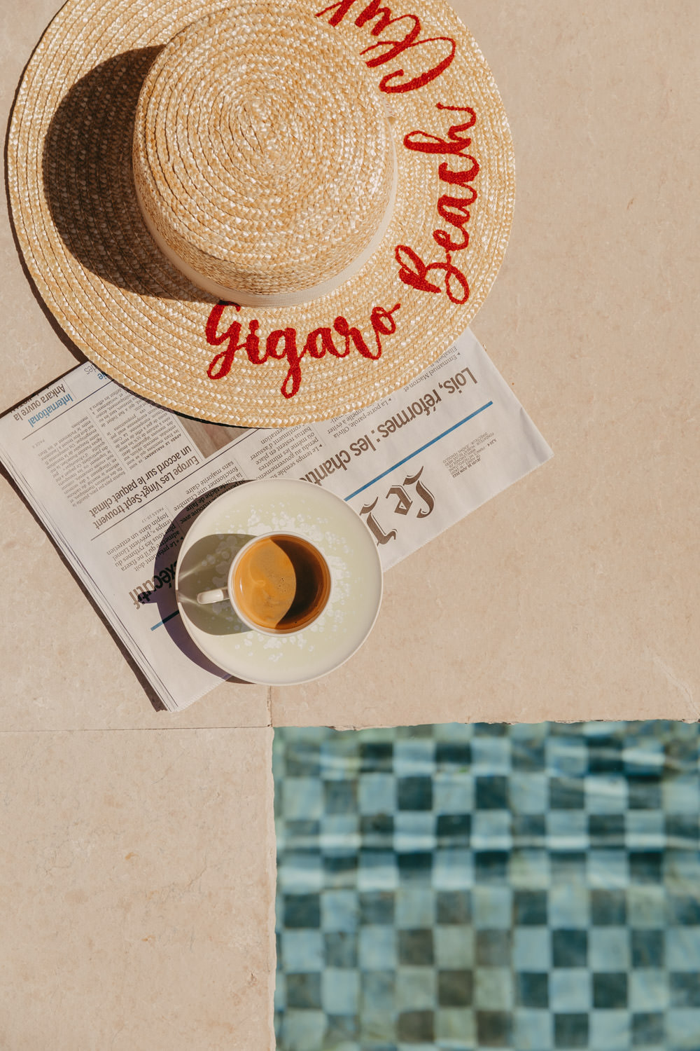 beach hat and coffee by the pool