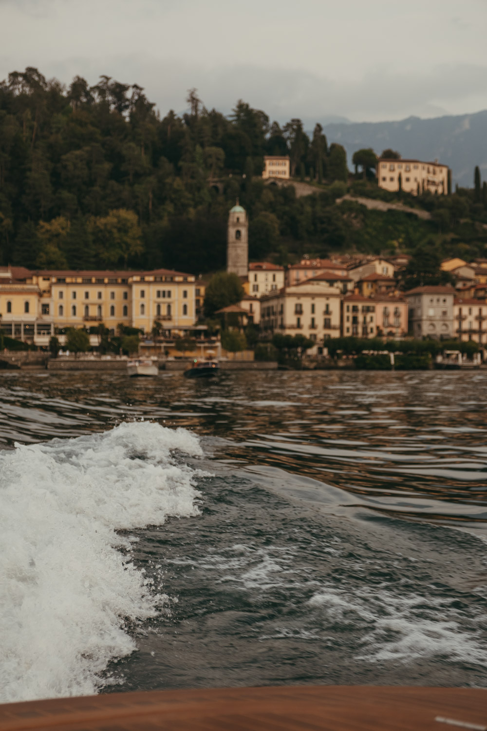 view of bellagio at sunset from a boat on lake como