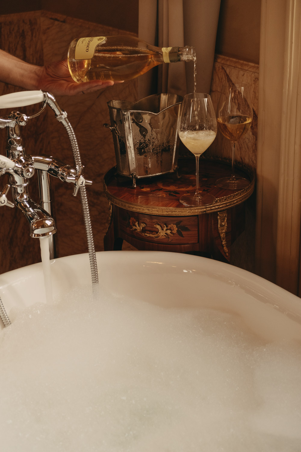 bubble bath and champagne being poured at passalacqua